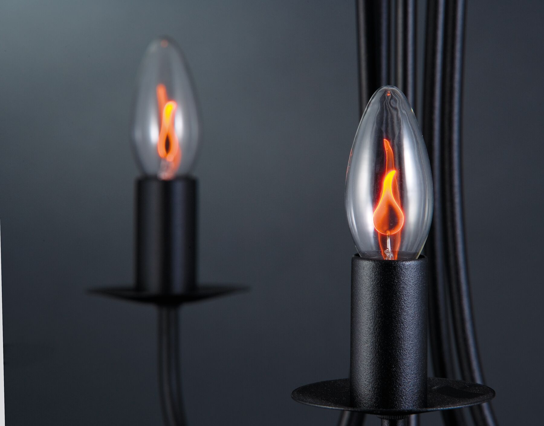 Black candle lamp with glass flame LED in warm orange for atmospheric lighting and decoration