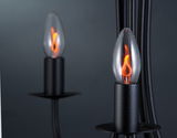 Black candle lamp with glass flame LED in warm orange for atmospheric lighting and decoration