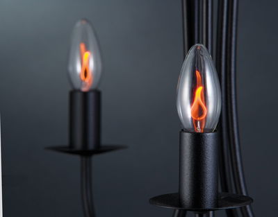 Black candle lamp with glass flame LED in warm orange for atmospheric lighting and decoration