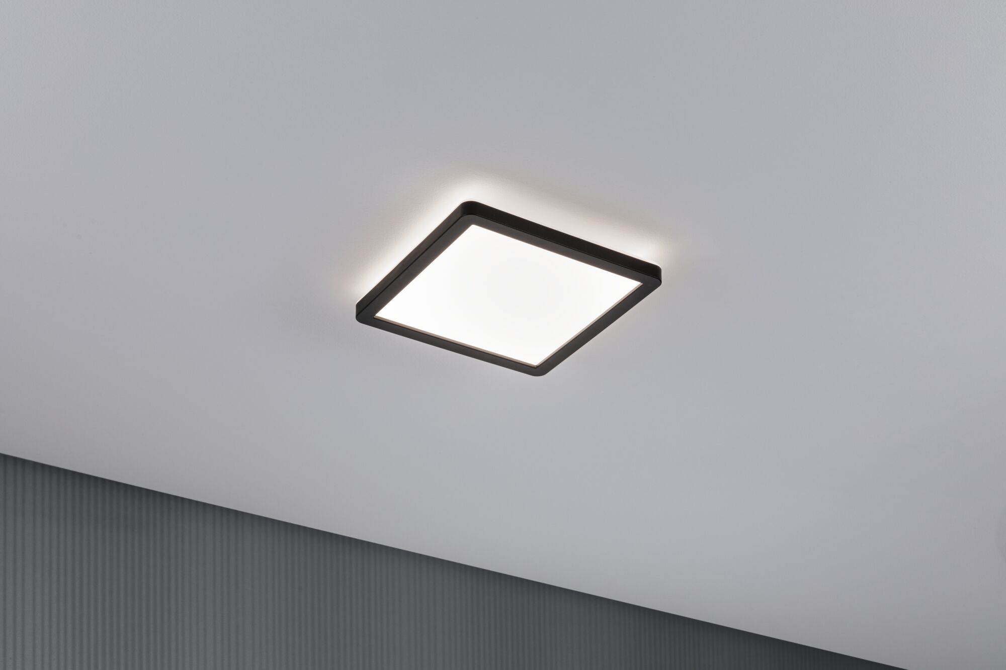Modern square LED ceiling light with black frame and warm white light for living spaces