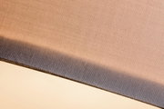 Close-up of beige and grey woven fabric material with fine texture and two-tone design