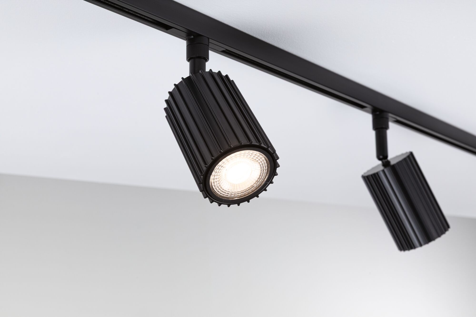 Black aluminium LED spotlight on track system for modern accent lighting in interiors