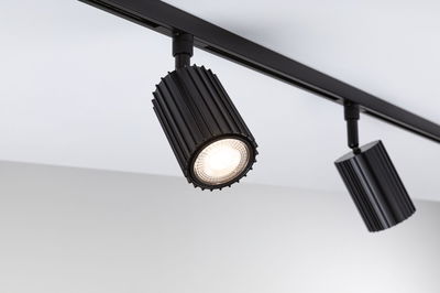 Black aluminium LED spotlight on track system for modern accent lighting in interiors
