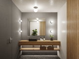 Salle de bain moderne avec meuble en bois, lavabo gris et appliques murales rondes pour un éclairage d'ambiance