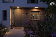 Modern house entrance with wood cladding and warm white LED ceiling lights for outdoor lighting.
