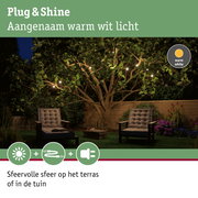 Sfeervolle tuinverlichting met warm wit licht aan boom en zithoek voor terras en tuin