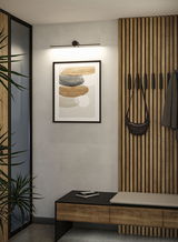 Modern hallway with wooden panels, bench and black wall light providing ambient LED lighting