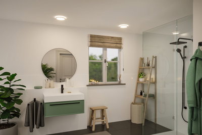 Moderne badkamer met ronde spiegel, groene wastafelkast en LED-plafondlampen voor helder licht