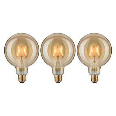 Three round LED bulbs with amber glass and visible filament for decorative lighting effects