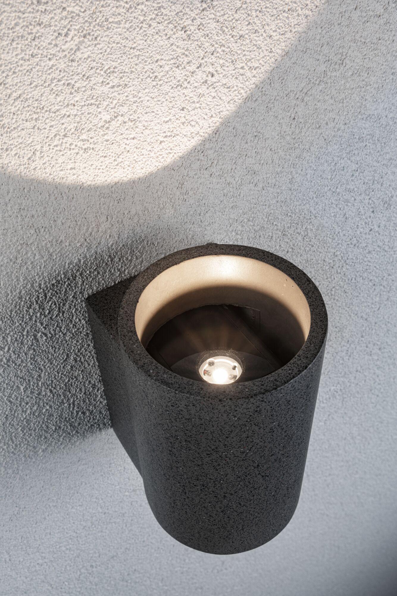 Schwarze Wandlampe aus strukturiertem Material mit warmweißem LED-Licht für moderne Innenbeleuchtung
