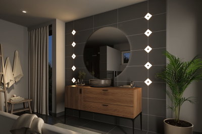 Modern bathroom with wooden vanity, round mirror, and warm white LED wall lights for ambient lighting.