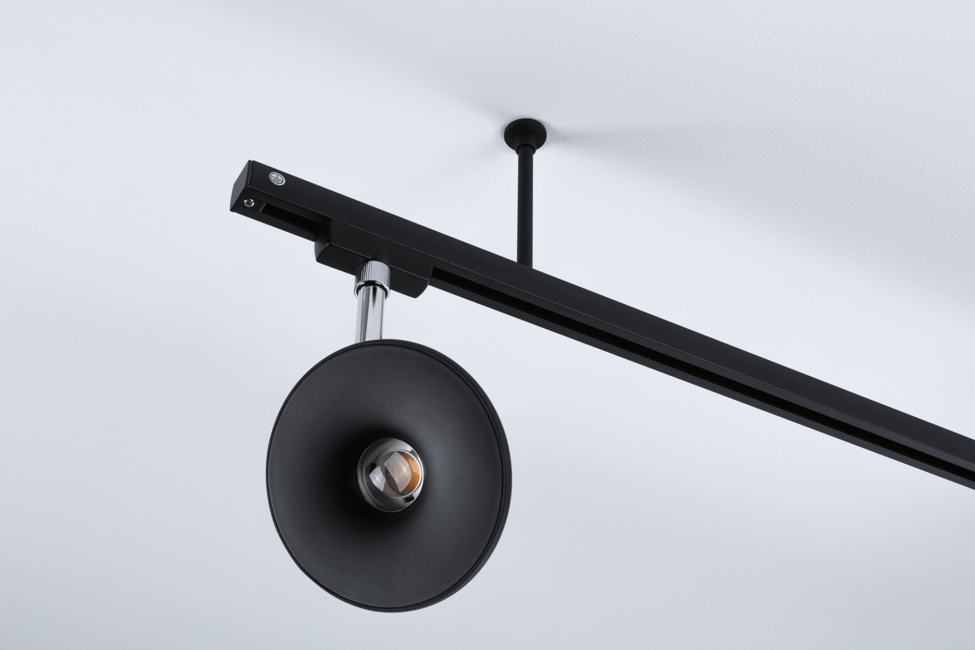 Black metal LED ceiling light with round reflector and adjustable spotlight for modern interior lighting