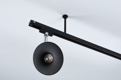 Black metal LED ceiling light with round reflector and adjustable spotlight for modern interior lighting