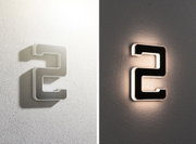 Moderne Hausnummer 2 aus Metall in Grau mit LED-Beleuchtung für Außenwände bei Tag und Nacht.