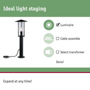 Black outdoor luminaire with clear glass and visible LED candle bulb for garden lighting