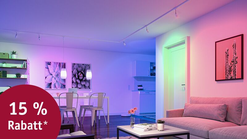 Modern living room with colour-changing LED lighting in white, blue and green for ambient home lighting