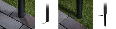 Installation of black metal ground sleeve with spike outdoors on grass and paving stones for garden lighting