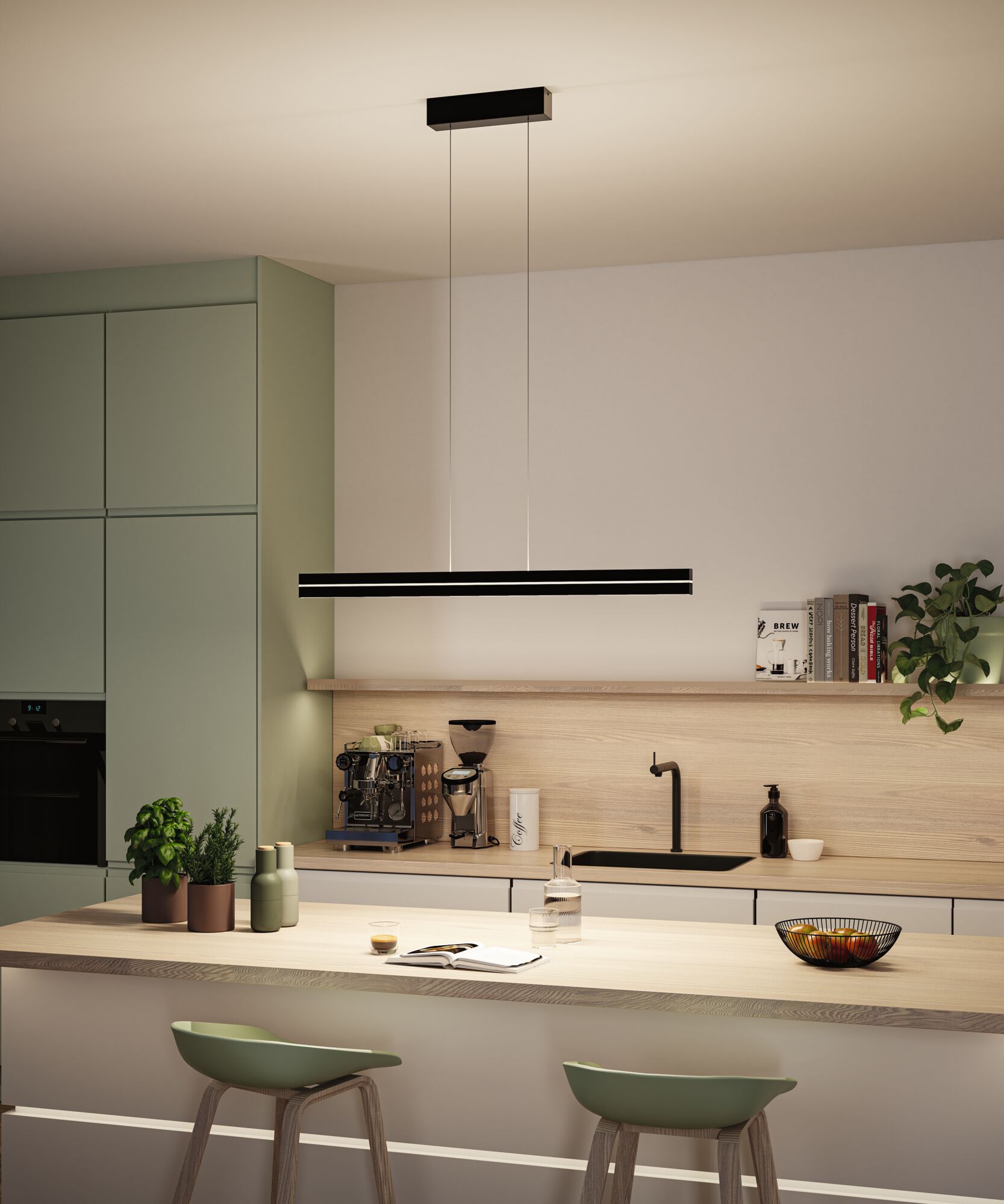 Modern kitchen with black LED pendant light above light wood countertop and green chairs