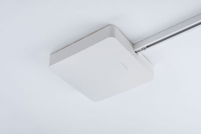 Square white ceiling light in plastic with rounded corners and track mounting system