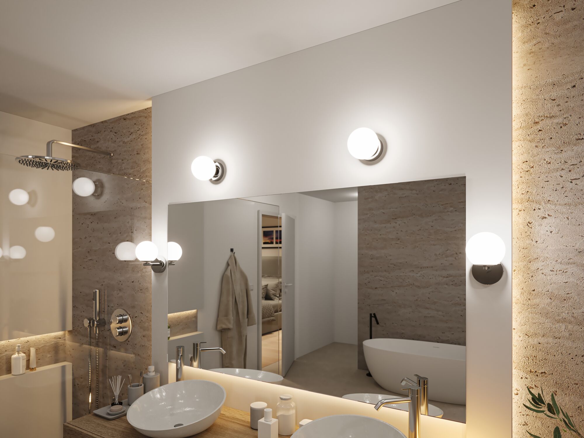 Salle de bain moderne avec appliques murales rondes en verre et chrome, éclairage LED lumineux et mur en pierre naturelle.