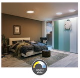 Modern bedroom with tunable white LED recessed ceiling lights for adjustable ambient lighting.