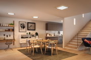 Modern round and square LED ceiling lights with warm white light in open kitchen dining area with wooden furniture