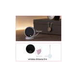 White round sensor with black face on table, wireless range 6 meters for smart home control device