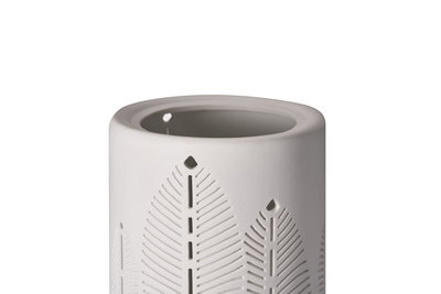 White ceramic oil burner with delicate leaf patterns for atmospheric home fragrance and lighting