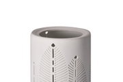 White ceramic essential oil burner with delicate leaf cutouts, decorative home fragrance accessory