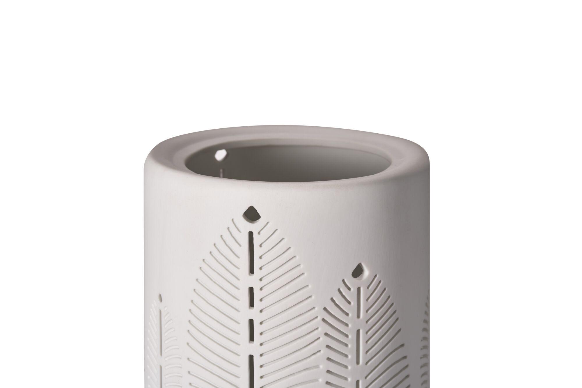 White ceramic essential oil burner with delicate leaf cutouts, decorative home fragrance accessory