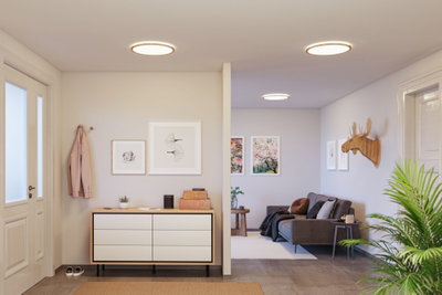 Modern living room with round ceiling lights emitting warm white light and minimalist decor