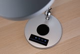 Silver lamp base with touch control and brightness slider on light wood table for LED desk lamp