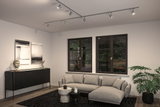 Modern living room with grey fabric sofa, black sideboard, and adjustable metal ceiling spotlights.