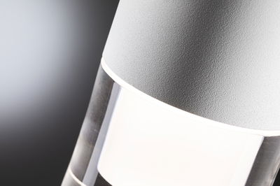 Close-up of modern grey LED outdoor light with clear glass and white light for garden lighting