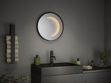 Miroir mural rond de salle de bain avec éclairage LED intégré noir, design moderne avec lavabo et robinet.