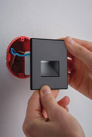 Installation of a square matte black LED wall recessed light with integrated driver and cable connection.