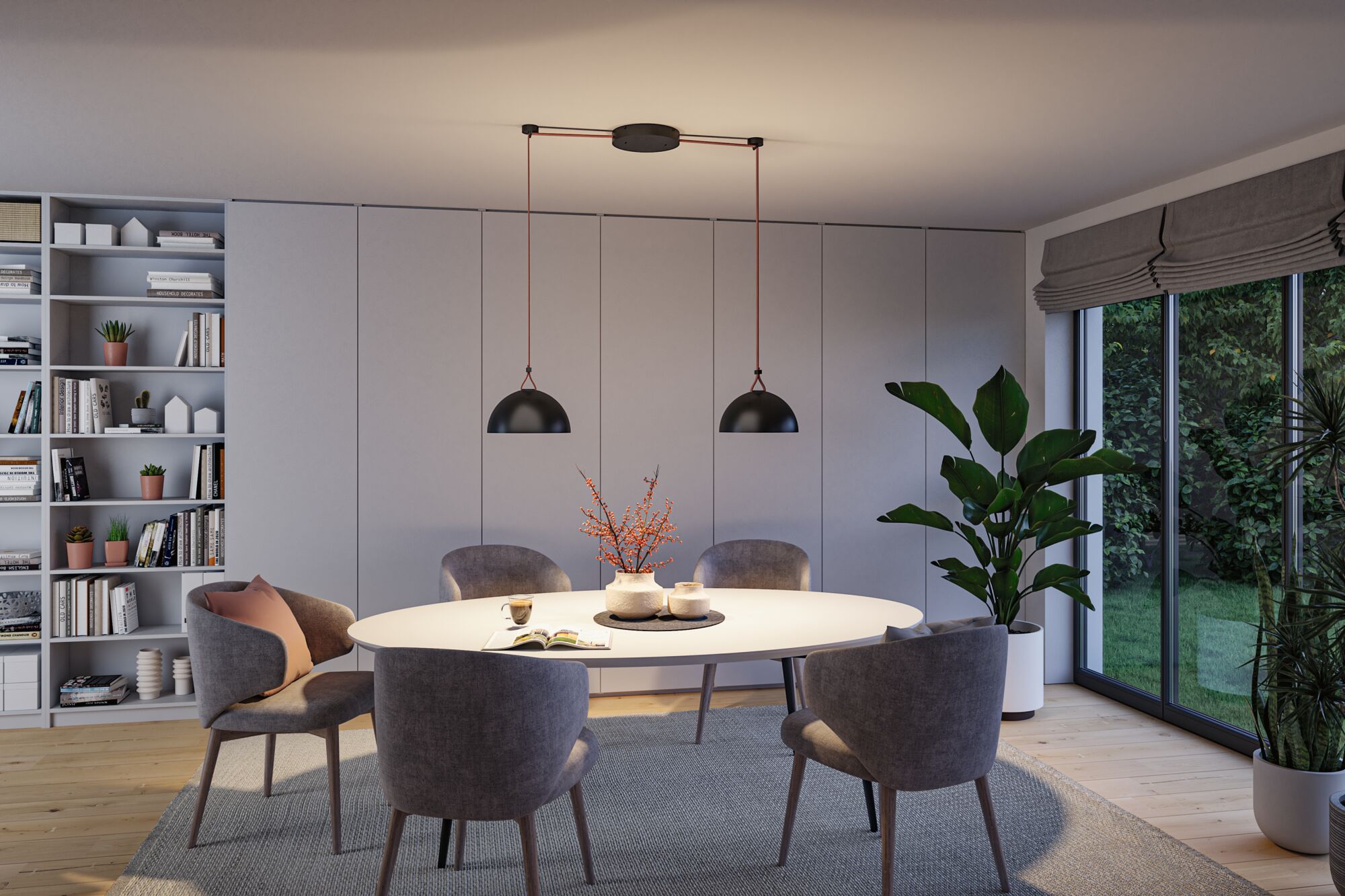 Modern dining area with white oval table, grey chairs, and two black metal pendant lights