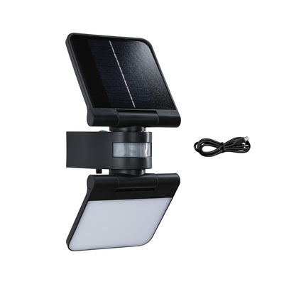 Black solar outdoor light with motion sensor and USB cable for energy-saving garden lighting
