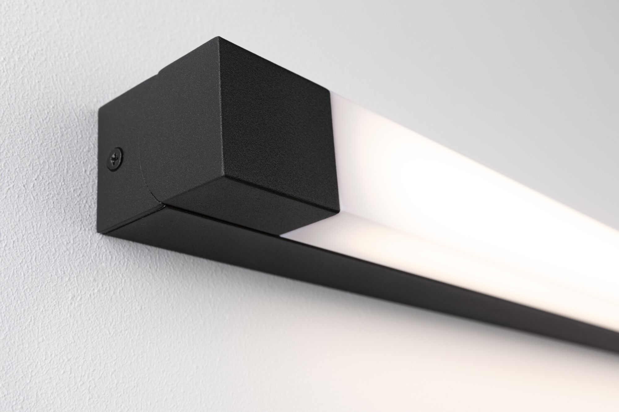 Black LED wall light with matte aluminum housing and white diffuser for modern indoor lighting