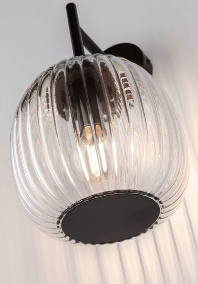 Wall lamp with ribbed clear glass and black metal base for modern home lighting design