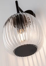 Wall lamp with ribbed clear glass and black metal base for modern home lighting design