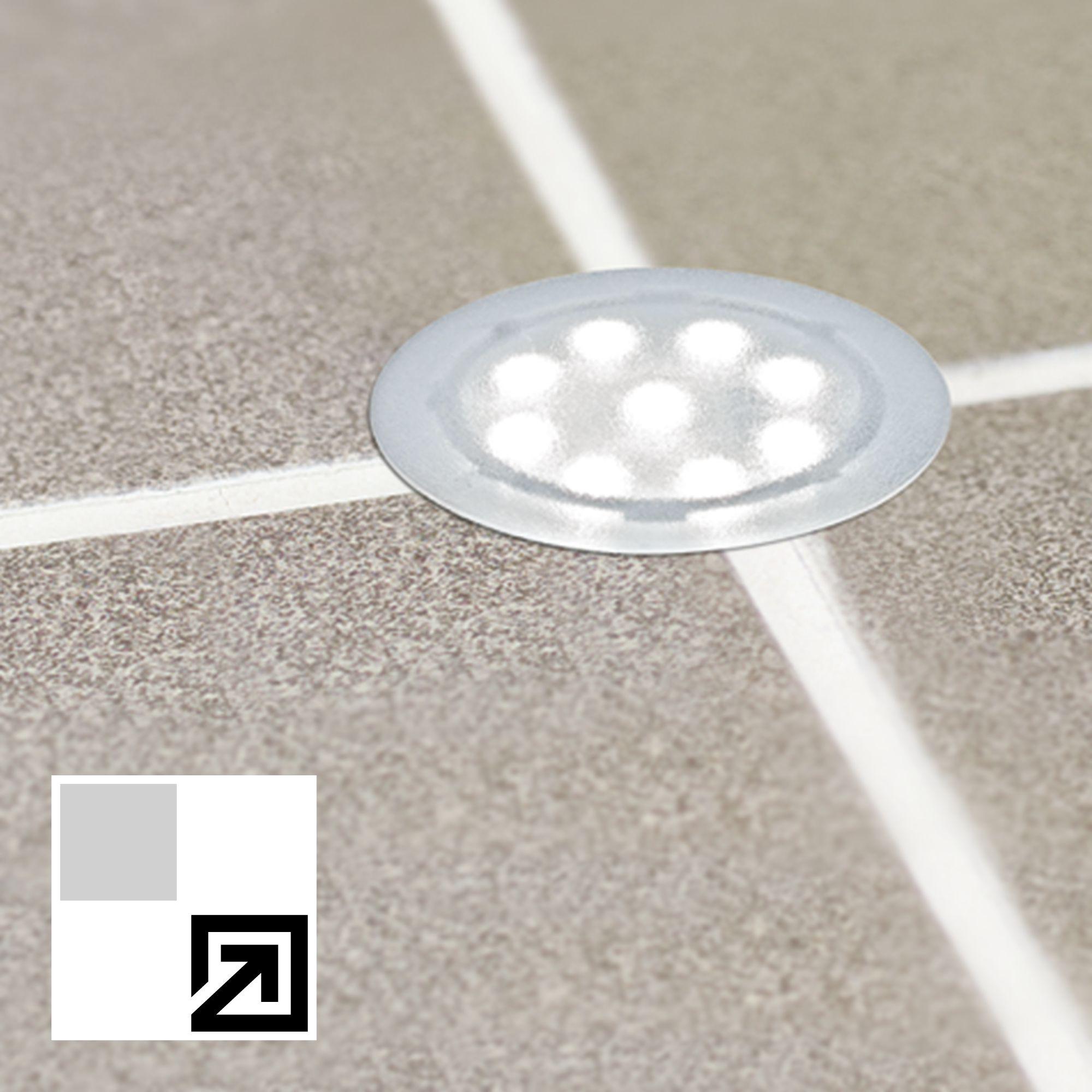 Lumière LED encastrée ronde avec cadre argenté sur carreaux gris pour éclairage extérieur