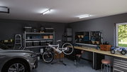 Modern garage with grey car, bike on repair stand, organized workbench and bright LED ceiling lights