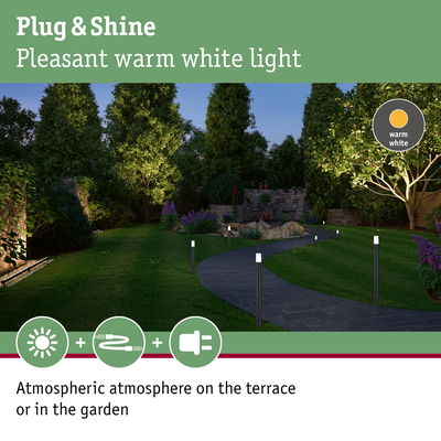 Garden path lit by warm white outdoor lights creating atmospheric terrace and garden lighting