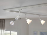 White LED track lighting with three adjustable spotlights in a modern living room with daylight.