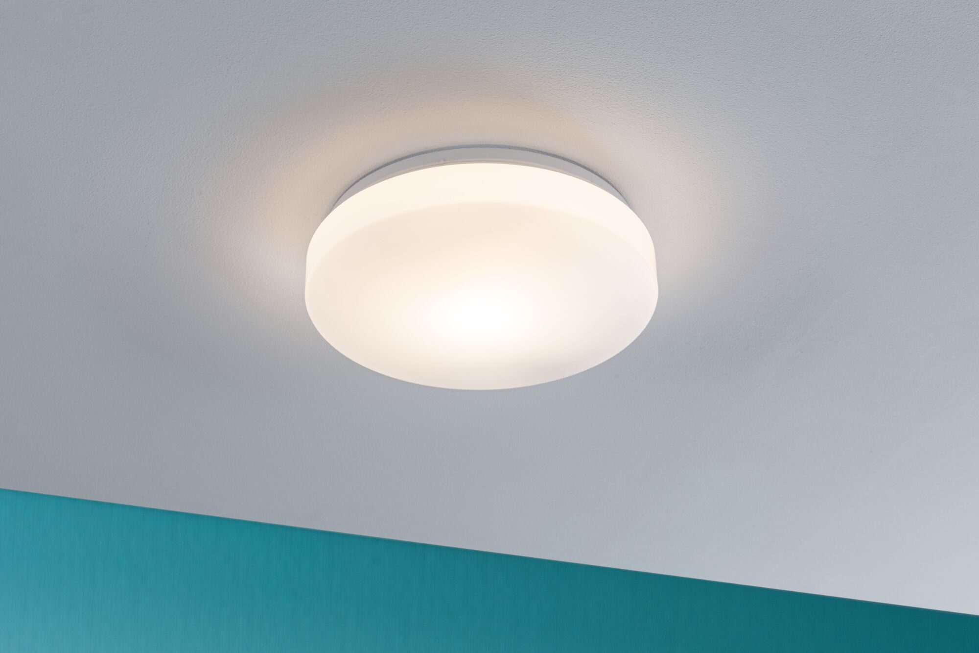 Plafonnier rond avec abat-jour en plastique blanc et lumière blanc chaud pour pièces à vivre.