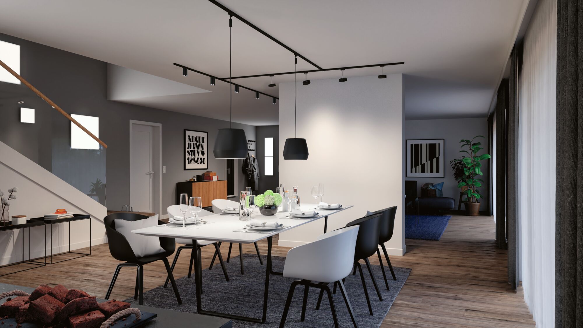 Modern dining area with black and white chairs, hanging black lamps, and wooden flooring in living space.