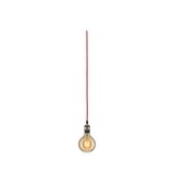 Hanging light bulb with red cable and warm glow for modern lighting design