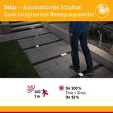 Solarbetriebene Bodenleuchten mit integriertem Bewegungsmelder beleuchten Gartenweg bei Nacht