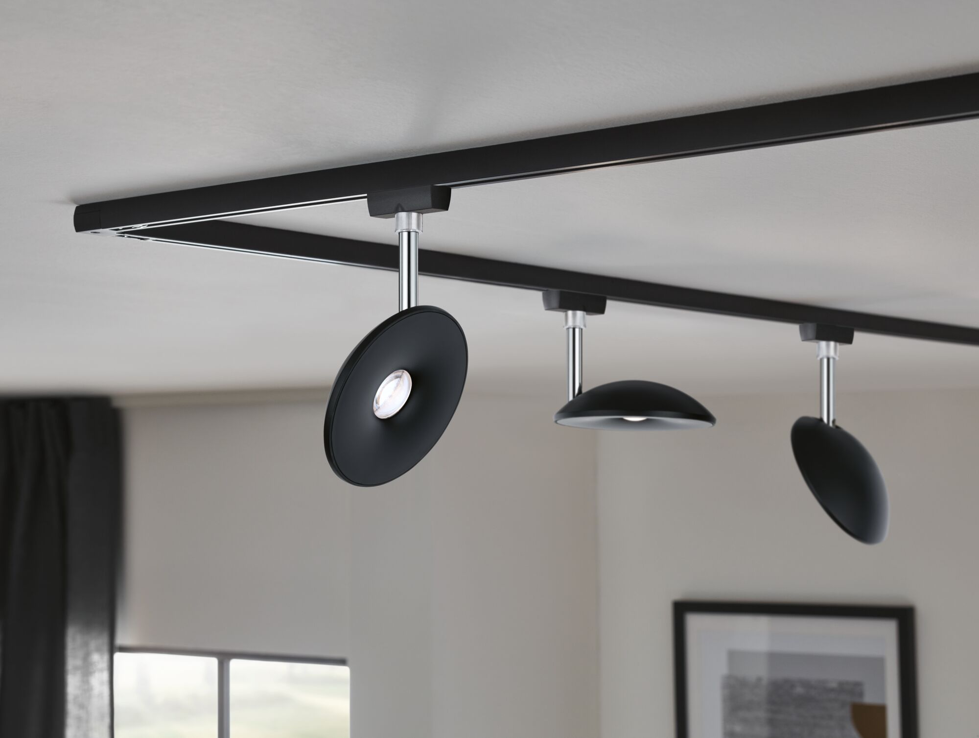 Black LED ceiling track with three adjustable metal spotlights for modern interior lighting